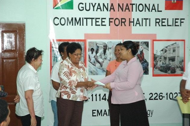 Minister Manickchand receives donation from a Representative of Women Reaching Out, Patrice Gordon.