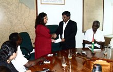Minister of Finance Dr. Ashni Singh hands over the cheque for $200M to Minister of Human Services and Social Security Priya Manickchand who chairs the National Committee for Haiti Relief