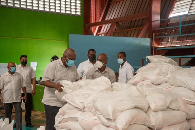 Prime Minister, Hon. Brigadier (ret’d) Mark Phillips and Director General of the Civil Defence Commission, Lt. Col. Kester Craig inspect the hampers being packed at the Gymnasium.